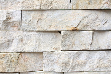 A white and grey brick wall. uneven surface. brick texture.