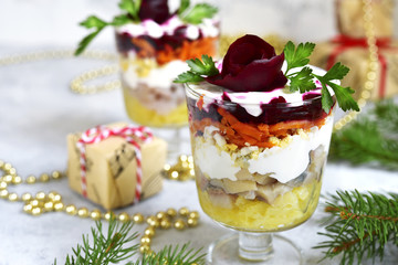 Traditional festive russian herring salad in a glass.
