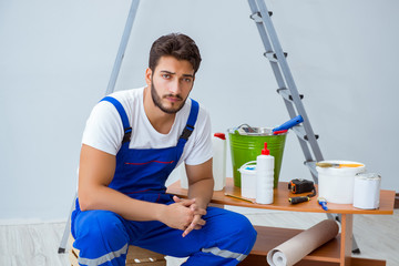 Obraz premium Repairman doing renovation repair in the house with paper wallpa