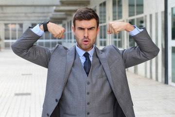 Elegant funny businessman flexing his muscles