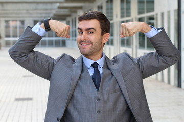 Elegant funny businessman flexing his muscles