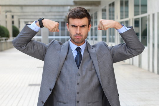 Muscular funny businessman flexing his muscles