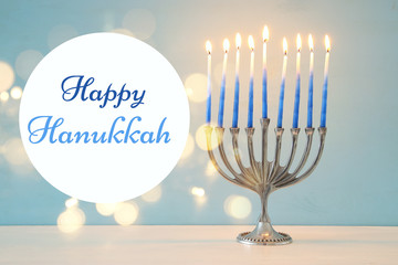 image of jewish holiday Hanukkah background with traditional menorah (traditional candelabra) and burning candles