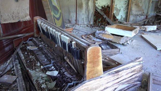 Chernobyl zone, Ukraine - 18th of June 2017: Visit to Duga radars (Soviet over-the-horizon radar system)- 4K Destroyed piano in the classroom at the deserted Duga station