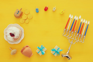 Obraz na płótnie Canvas Top view image of jewish holiday Hanukkah background with traditional spinnig top, menorah (traditional candelabra)