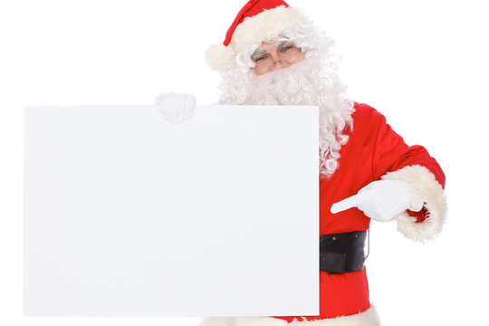 Santa Claus pointing on blank white wall, advertisement banner with copy space. Isolated on white background