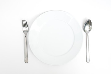 empty new ceramics plate with spoon and fork on white background - Top view