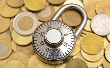 Padlock on Currency coins background security concept