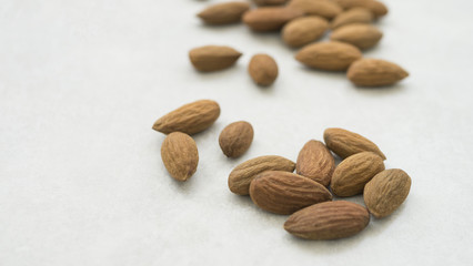 dried almonds on white grey background