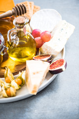 Cheese board with cranberry and autumn fruits