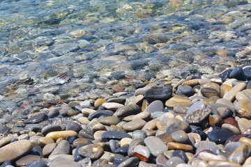Amazing sea pebbles under water on the beach