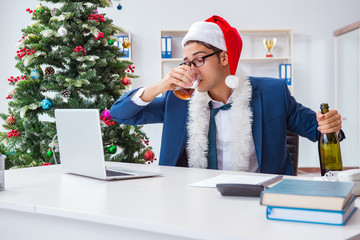 Businessman celebrating christmas holiday in the office