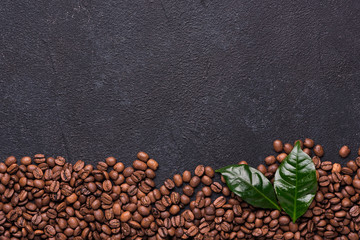 Coffe beans with coffe leaves on black background