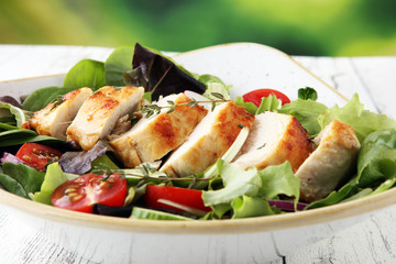 Chicken salad with leaf vegetables and cherry tomatoes.