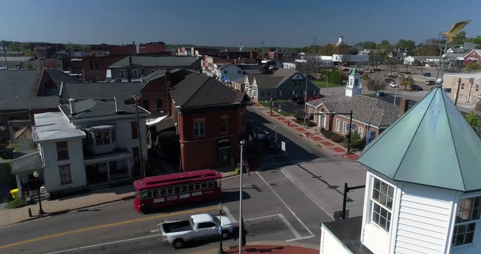 A slow forward dolly aerial establishing shot of the small town of Salem, Ohio's business district.  	