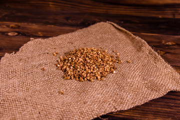 Pile of the raw buckwheat on sackcloth