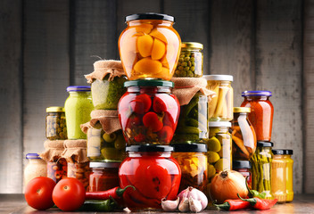 Jars with variety of pickled vegetables.