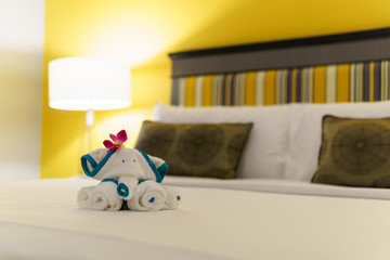 close up, Towels are folded into elephants shape for bathroom accessories preparation on the bed in a room of hotel or apartment. well preparation of bath facilities for hotel services for hotel guest