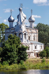 Fototapeta na wymiar Old stone Orthodox Church on the banks of the river in Russia.