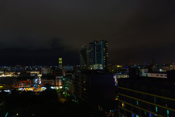 Fototapeta na wymiar beautiful panorama landscape view of pattaya city at night after rain. cityscape at night with dark sky and cloud. business downtown city at night.