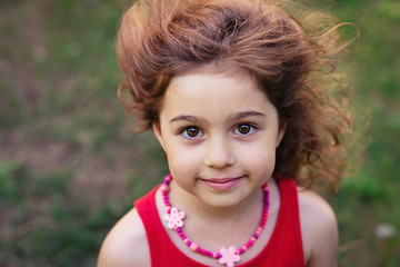 Portrait of cute little girl smiling outside