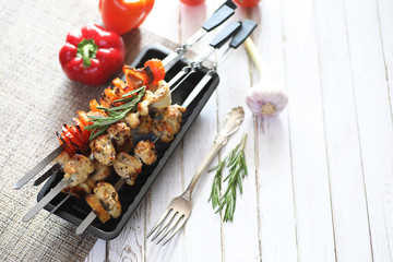 Kebab cooked on metal skewers with vegetables