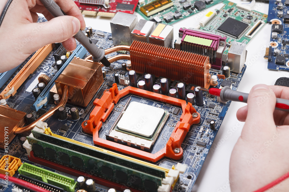 Poster engineer checking motherboard with multimeter