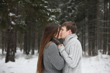 Fototapeta premium pair of lovers on a date winter afternoon in a snow blizzard