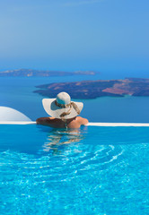 Woman relaxing in infinity swimming pool