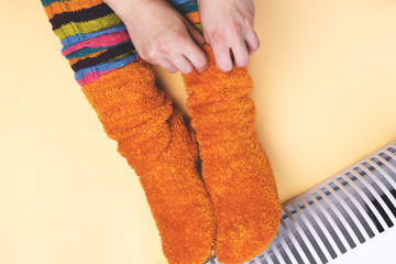 Girl hot near the heater in socks