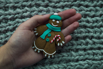 Christmas gingerbread man in hand on background close-knit - 176739980