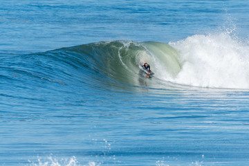 Bodyboarder surfing ocean wave