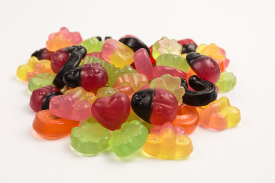 pile of fruity gummy candies with good luck symbols