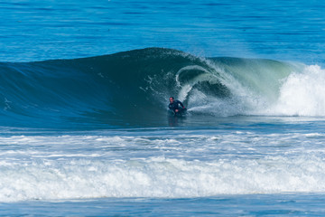 Bodyboarder surfing ocean wave