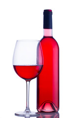 High glass with still rose wine and wine bottle isolated on white background