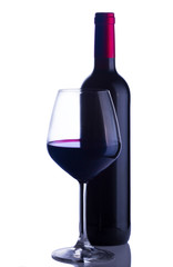 High glass with still red wine and wine bottle isolated on white background