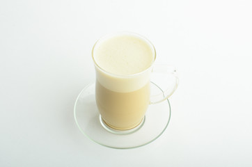 A cup of latte coffee with shaped milk foam isolated on white background