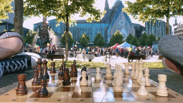 Playing chess on the lawn against the background of Augustusplatz Leipzig