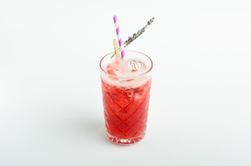 Red berry lemonade with ice decorated lavender in glass isolated on white background
