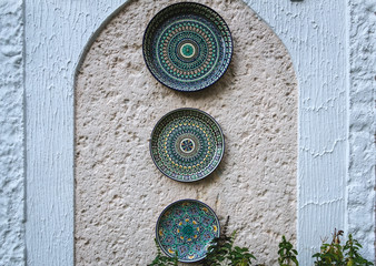 Ethnic Uzbek ceramic tableware. Decorative ceramic plate with traditional uzbekistan ornament.