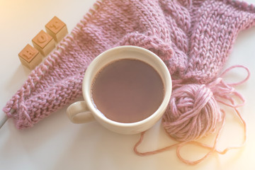Top View Cozy Incomplete Crochet Project Winter Warm Sweater Gentle Pink Tones Wool Cotton Yarn Cup Coffee Needles White Wooden Table. Natural Wool Knitting Background. Cosiness concept.
