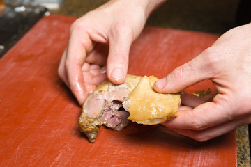 A free range, succulent cooked duck leg fillet, being cut open to reveal the freshly cooked tender duck meat and golden tasty duck skin.