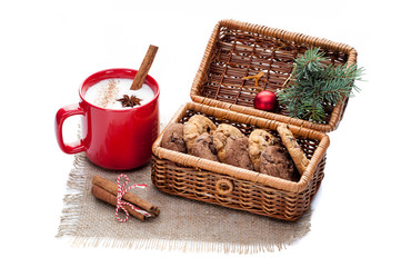 eggnog cocktail in red mug arranged with christmas decoration and cookies box isolated on white