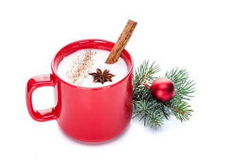 eggnog cocktail in red mug arranged with christmas decoration isolated on white
