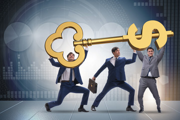 Businessmen holding giant key in finance concept