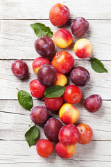 Fresh ripe peaches and plums © evgeeenius