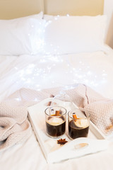 Breakfast in bed for two - tray with cup of coffee and sweet marshmallows, cozy winter hygge home style