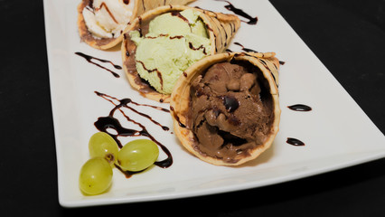 Ice cream in a waffle cup on a white plate