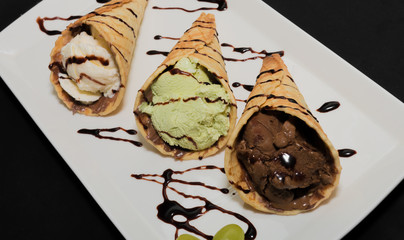 Ice cream in a waffle cup on a white plate