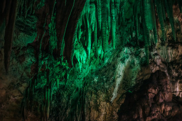 Beautiful illuminated limestone stalactites in Adygeya underground cave